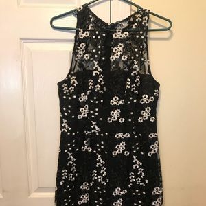 black mini dress with lace and white flower design
